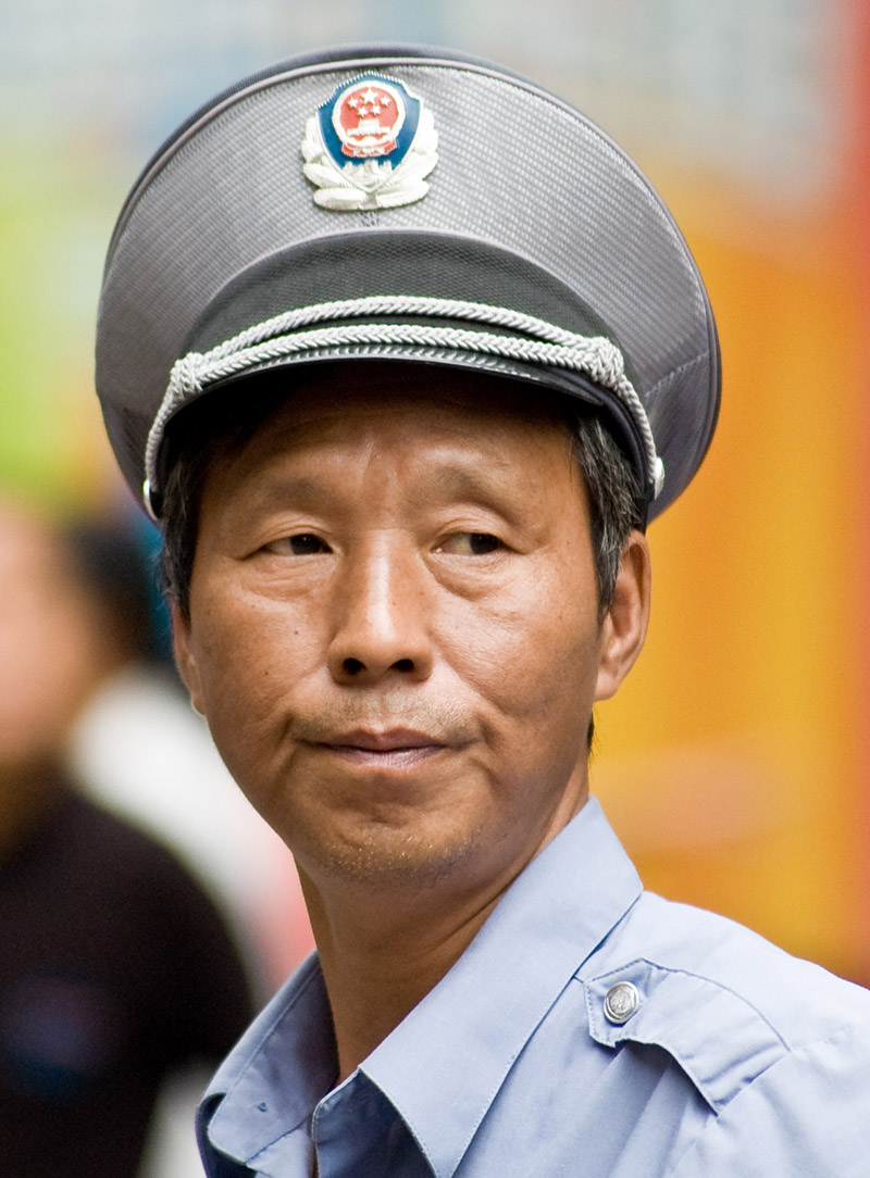 Chinese officer @ Shanghai downtown market by Dusan Simonovic